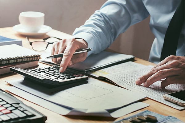 Man Using A Calculator — Accounting in Bundall, QLD